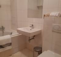 Bathroom in a 3-room apartment with a bathtub, sink, and toilet.