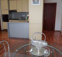 Kitchen and dining area in a 3-room apartment with a wooden decor floor.