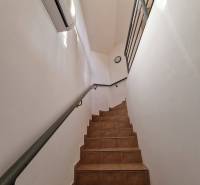 Interior of commercial premises with ceramic stairs and white walls.