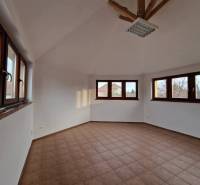 Interior of commercial spaces with tiling and large windows, providing plenty of natural light.