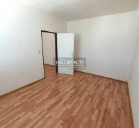 An empty room with a wooden decor floor in a 2-room apartment.