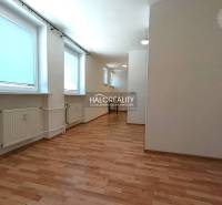 A bright room with covered windows, heating, and a wooden decor floor in a 2-room apartment.