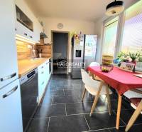 A kitchen in a 3-room apartment with tiles and wooden decor, bright and spacious.