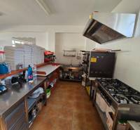 The kitchen of gastro spaces with professional appliances and supplies on wooden decor flooring.