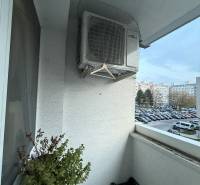 Balcony of a 4-room apartment on Kríkova Street, Bratislava - Vrakuňa with a flower pot and air conditioning.