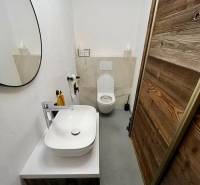 A bathroom in a 3-room apartment with a mirror, sink, and modern decoration.