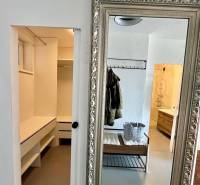 A mirror with a decorative frame and a spacious dressing room in a 3-room apartment.