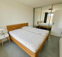3-room apartment with a bed, wardrobe, nightstand, and mirrored doors.