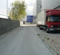 On Stará Vajnorská Street, a red truck near the warehouse halls.
