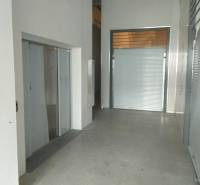 Interior in a warehouse and hall with white and metal surfaces.