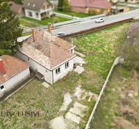 A family house in Michal na Ostrove with a grassy yard and an asphalt road.