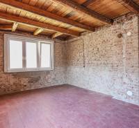 Interior of a family house with brick walls and a window, floor with wooden decor.
