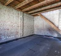 Room with brick walls and wooden beams in a family house.