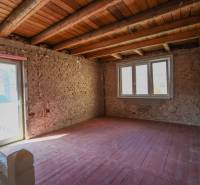 Interior in a family house with brick walls and large windows, floor with wooden decor.