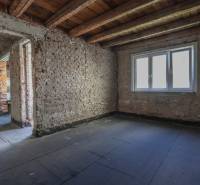 Raw brick walls and ceiling in the process of renovation in a family house.