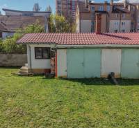 The garden of a family house on Hviezdoslavova Street in Piešťany with an older annex and a lawn.