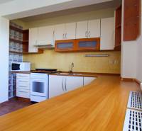 Kitchen in a 3-room apartment, front view, kitchen unit with wooden decor.