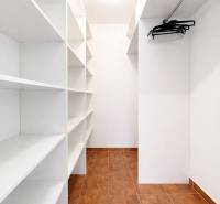 Entrance hall with built-in shelves and hangers, in a 3-room apartment with tiled flooring.