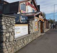 Offices in Poprad with a stylish stone facade and an advertisement for space rental.