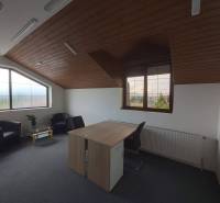 Offices with wood-patterned flooring, a desk, and carpets.