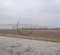 Commercial land on Priemyselná Street in Zohor, next to a large building and road.