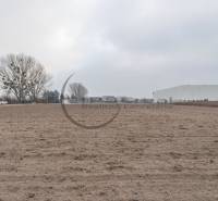 Commercial land on Priemyselná Street in Zohor with a building in the background.