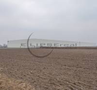 Industrial Street in Zohor, extensive commercial plots with a large building in the background.