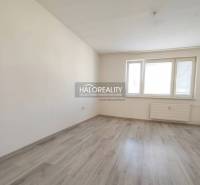 A room in a 3-room apartment with a wooden decor floor and white walls.