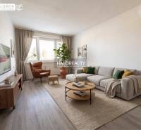 Living room of a 3-room apartment with a large sofa, an armchair, and a floor with a wood decor.