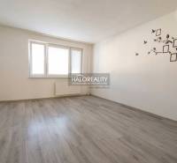 A room in a 3-room apartment with a wooden decor floor and white walls.