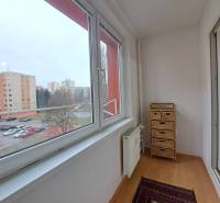 A glazed balcony in a 2-room apartment with a view of the housing estate in Poprad.