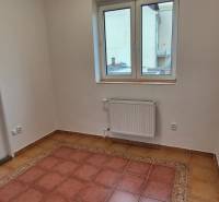 A room in a 3-room apartment with tiles, white walls, and a window.