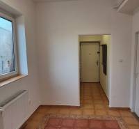 A hallway with a light coat of paint and a large window in a 3-room apartment.