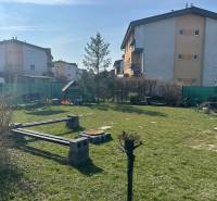 Grass area with benches and apartment buildings on M.R.Štefánika Street, Most pri Bratislave.