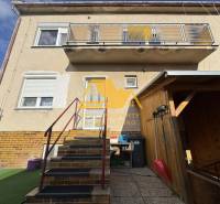 Family house in Tvrdošovce on Tvrdošovce street with an outdoor staircase and a balcony.