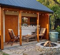 A garden in Galanta with a garden house, wooden cladding, and a seating area.