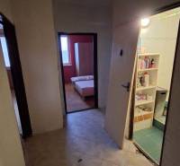 The entrance hall of a 3-room apartment with a view into other rooms, the floor is tiled.