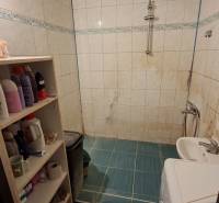 Bathroom in a 3-room apartment with a tiled floor and a washing machine.