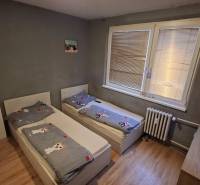 A children's room with two beds and a wooden decor floor in a 3-room apartment.