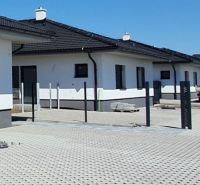 A family house on Leknová Street in Láb with a pitched roof and a paved driveway.