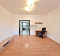 A room in a 4-room apartment with a wooden decor floor and a work desk.