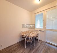 Dining area with a table, chairs, and flooring with a wooden decor in a 4-room apartment.
