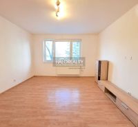 Living room with light walls and a wooden decor floor in a 4-room apartment.