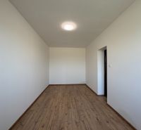 A family house with white walls and a wooden decor floor.