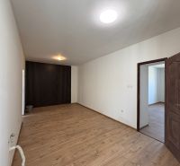 Interior of a family house with a wooden decor floor and white walls.