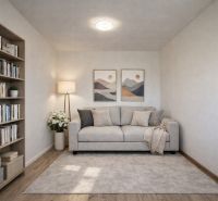 Living room in a family house with a sofa, bookshelf, and wooden decor flooring.