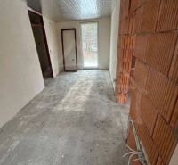 Bare walls and concrete floor in the cabin, preparation for further modifications.