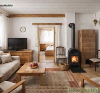 Living room in a family house with a tiled stove and a floor with a wood decor.