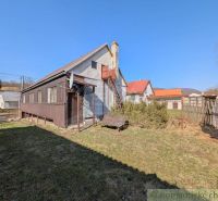 A family house in Kalinovo with a veranda and a hilly background.