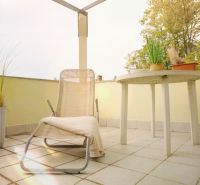 The balcony of a 5 or more room apartment in Rajecké Teplice with plants and furniture.
